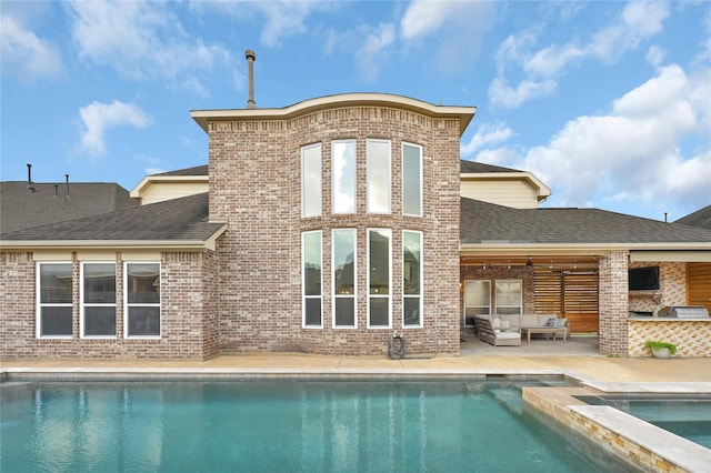 rear view of house with a swimming pool with hot tub, an outdoor living space, and a patio