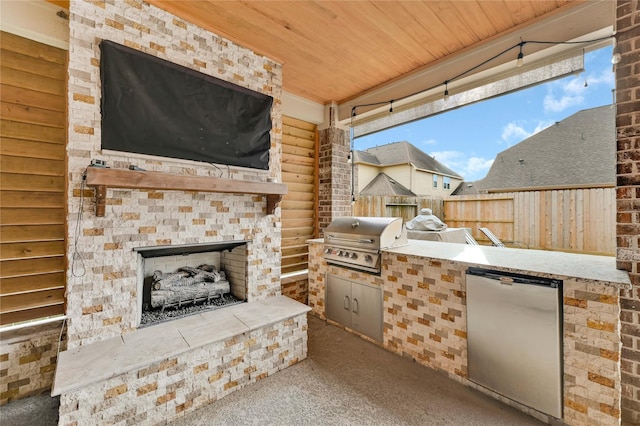 view of patio / terrace featuring area for grilling, exterior fireplace, and exterior kitchen