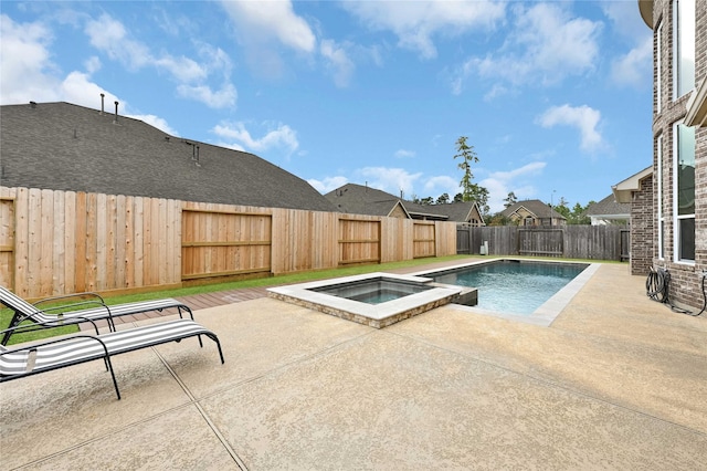 view of pool with an in ground hot tub and a patio area