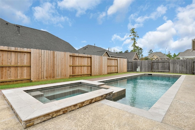 view of swimming pool with an in ground hot tub