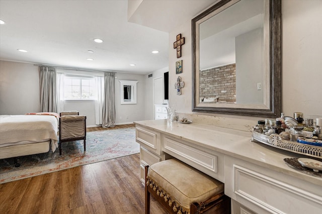 bathroom with hardwood / wood-style flooring and vanity