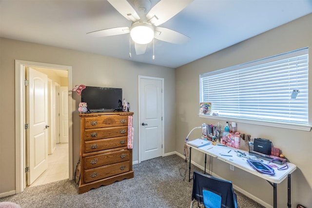 office featuring light carpet and ceiling fan