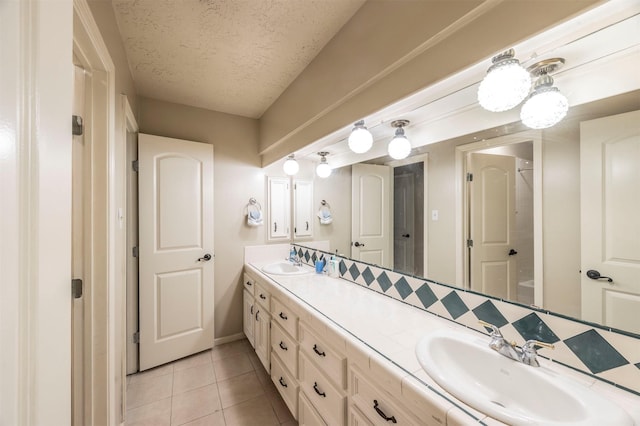 bathroom with vanity, tile patterned flooring, and a textured ceiling