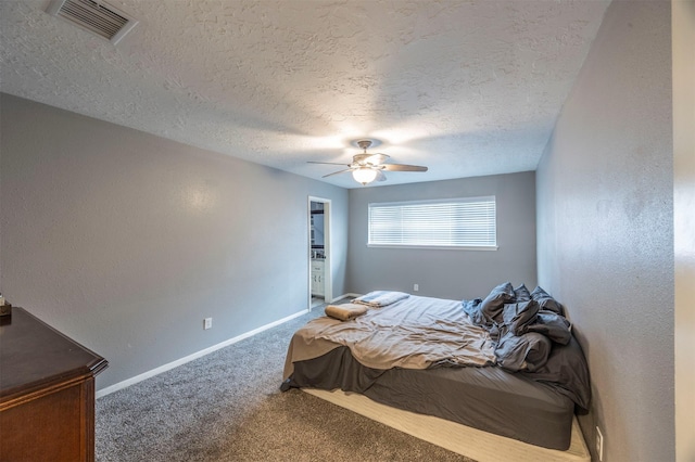 carpeted bedroom featuring a textured ceiling and ceiling fan