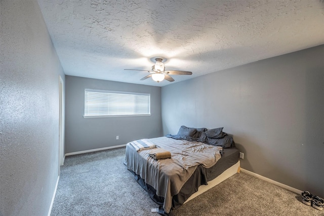 carpeted bedroom with ceiling fan and a textured ceiling