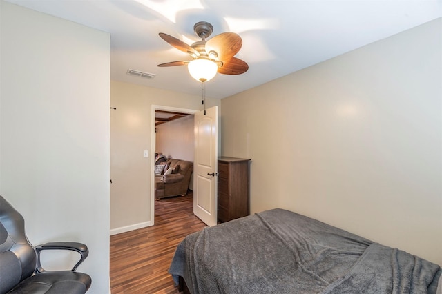 bedroom with dark wood-type flooring and ceiling fan