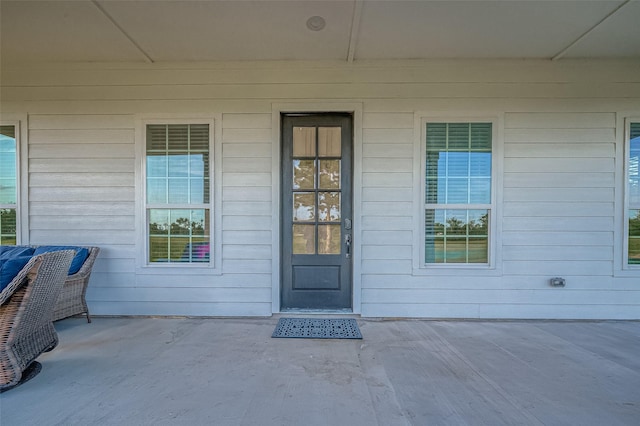 view of exterior entry with a porch