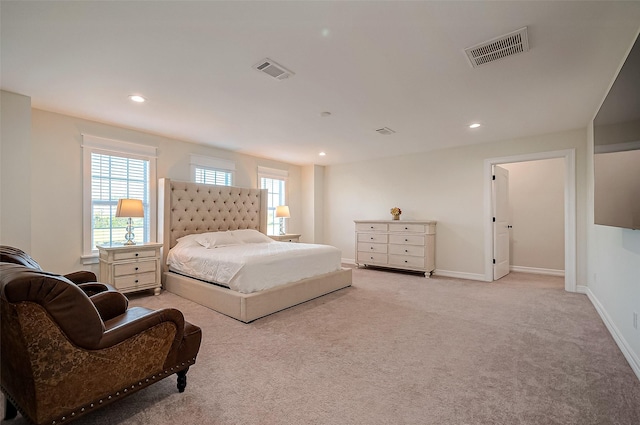 bedroom featuring multiple windows and light carpet