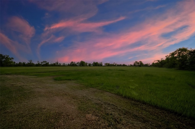 nature at dusk featuring a rural view