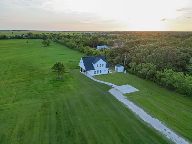 aerial view at dusk featuring a rural view