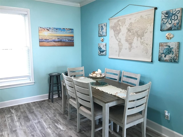 dining area featuring ornamental molding and wood-type flooring