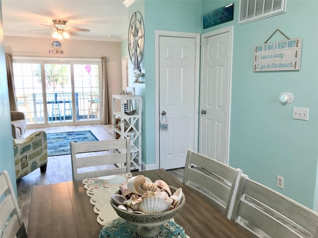 interior space featuring wood-type flooring, ornamental molding, and ceiling fan