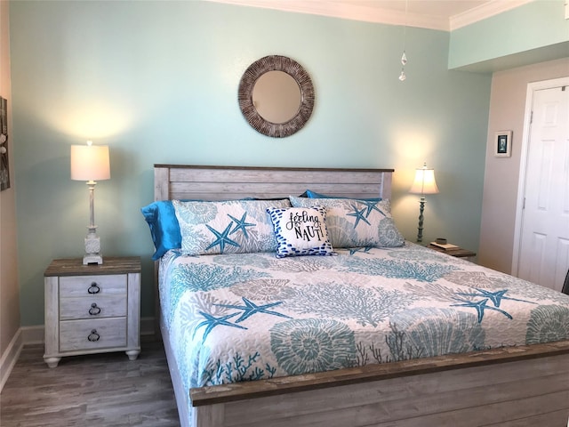 bedroom with crown molding and dark hardwood / wood-style floors