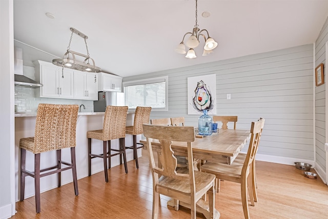 4231 Spanish Main, Jamaica Beach, TX 77554 - dining space featuring a notable chandelier, sink, and light wood-type flooring