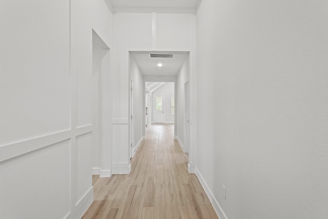 corridor with light hardwood / wood-style floors