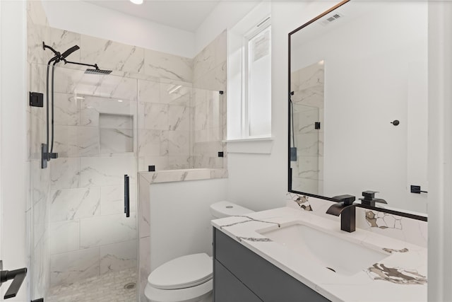 bathroom featuring walk in shower, vanity, and toilet