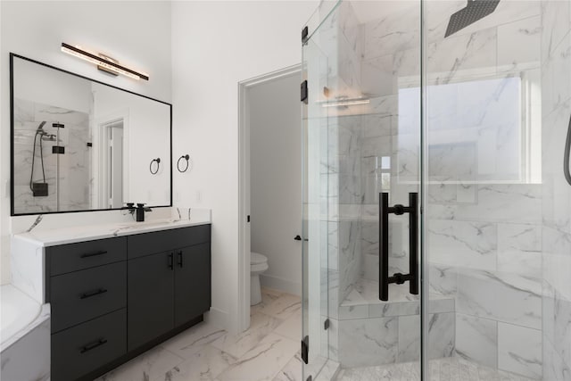 bathroom with a shower with door, vanity, and toilet