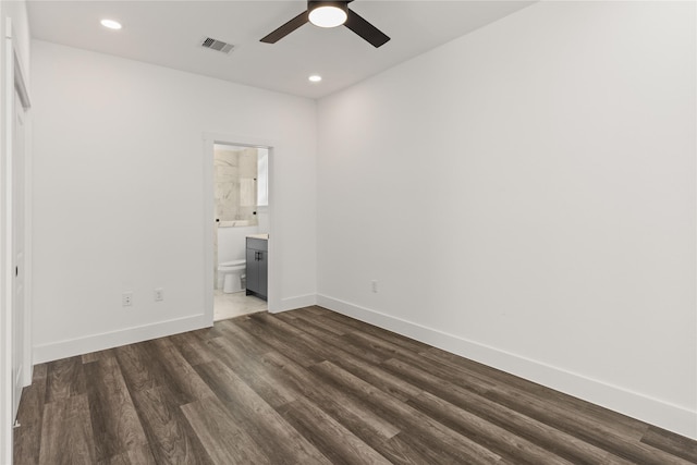 unfurnished bedroom featuring ceiling fan, dark hardwood / wood-style floors, and ensuite bath