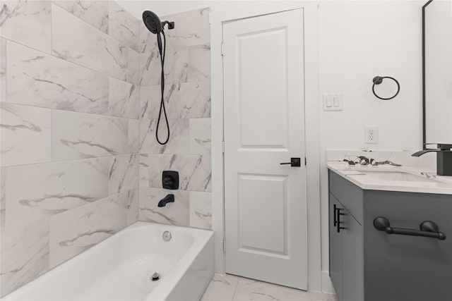 bathroom featuring tiled shower / bath combo and vanity