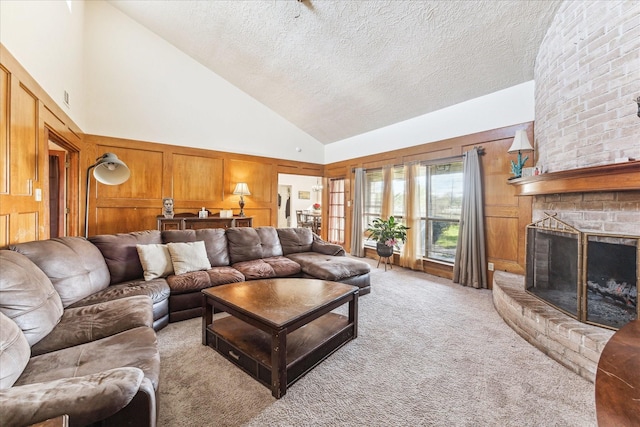 living room with light carpet, a fireplace, high vaulted ceiling, and a textured ceiling