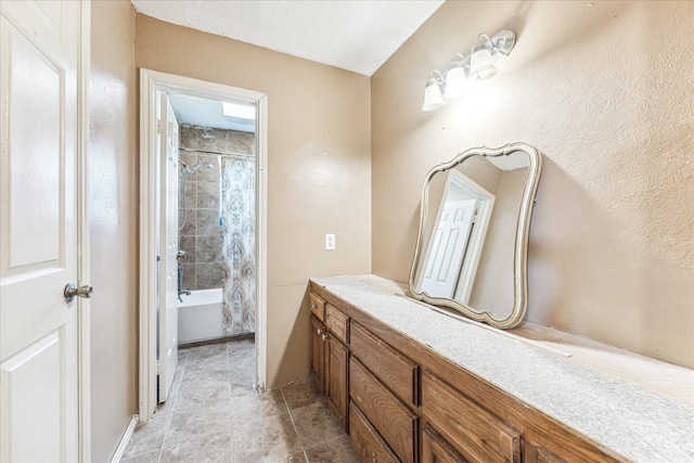 bathroom featuring vanity and shower / bath combo