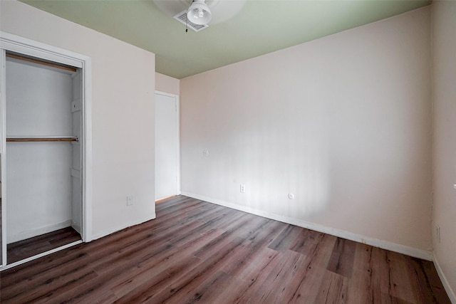 unfurnished bedroom featuring wood-type flooring and a closet