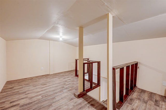 bonus room featuring wood-type flooring and lofted ceiling