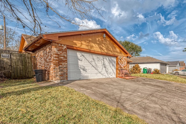 view of side of home with a garage and a lawn