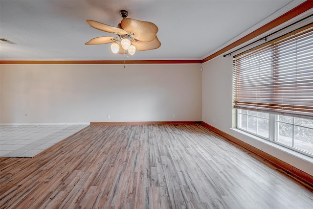 unfurnished room with ceiling fan, ornamental molding, and light hardwood / wood-style flooring