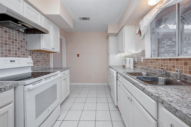 kitchen with light tile patterned flooring, sink, extractor fan, white appliances, and white cabinets