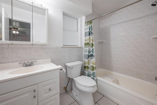 full bathroom featuring tile patterned flooring, tile walls, vanity, shower / bath combination with curtain, and toilet