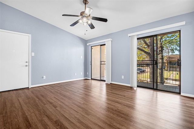 empty room featuring lofted ceiling, wood-type flooring, and ceiling fan