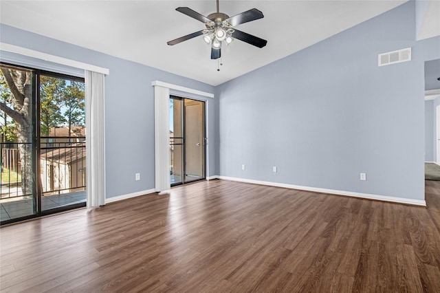 empty room with ceiling fan, lofted ceiling, and dark hardwood / wood-style flooring