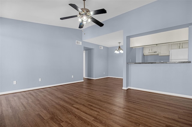 unfurnished living room featuring hardwood / wood-style flooring, ceiling fan with notable chandelier, and vaulted ceiling