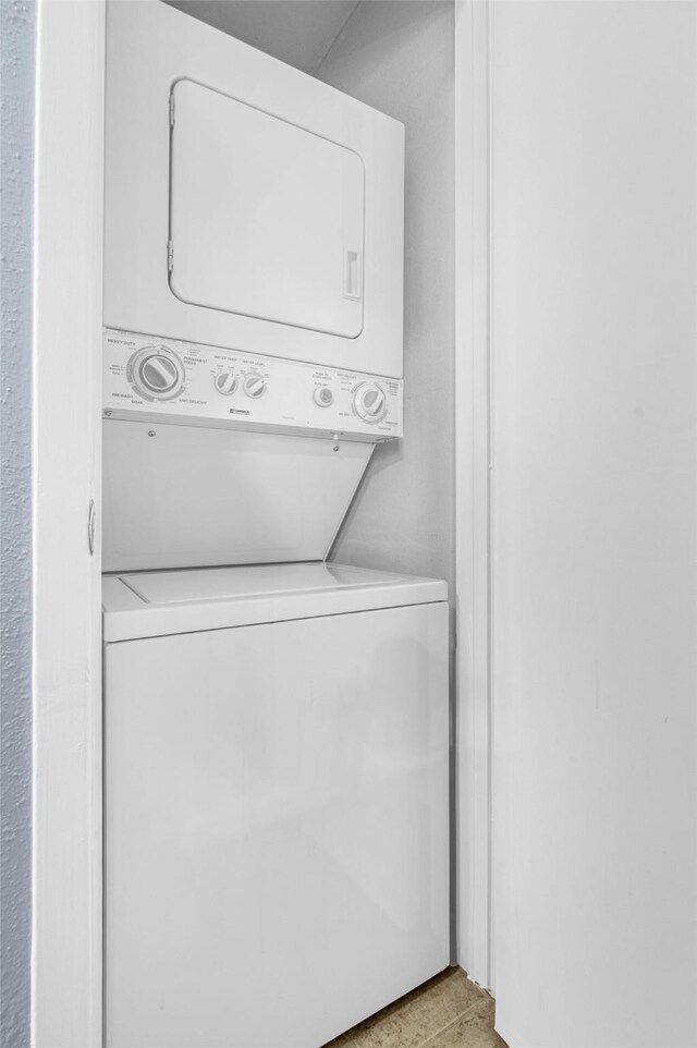 washroom with estacked washer and dryer