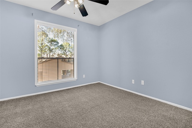 carpeted spare room with ceiling fan