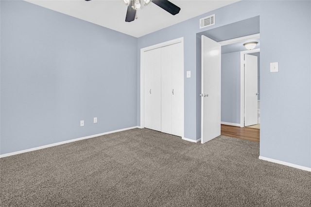 unfurnished bedroom featuring carpet floors, ceiling fan, and a closet