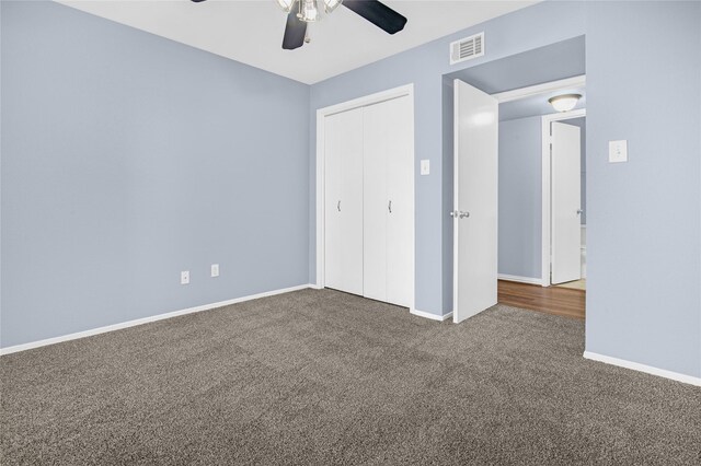 unfurnished bedroom with carpet, a closet, baseboards, and ceiling fan