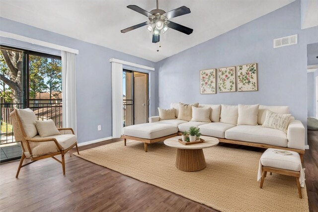 living room featuring wood finished floors, ceiling fan, vaulted ceiling, and baseboards