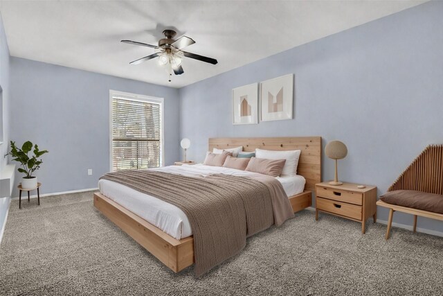 carpeted bedroom featuring baseboards and ceiling fan