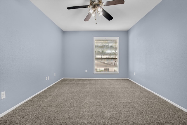 unfurnished room featuring ceiling fan and carpet