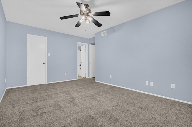 spare room featuring ceiling fan and carpet floors