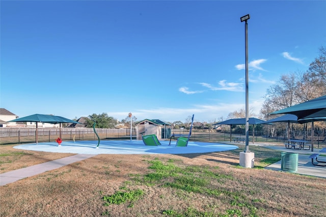 view of swimming pool featuring basketball hoop and a lawn