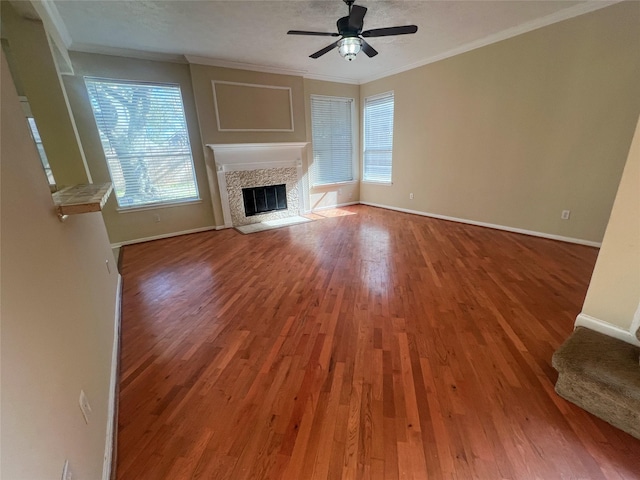 unfurnished living room with ornamental molding, wood-type flooring, ceiling fan, and a textured ceiling