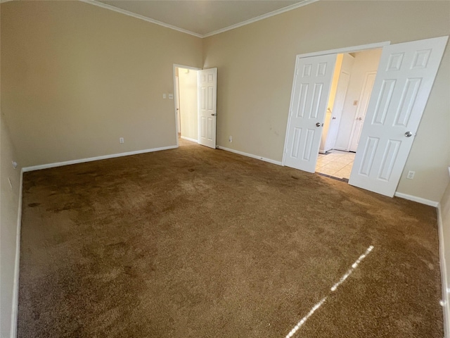 empty room featuring crown molding and light colored carpet