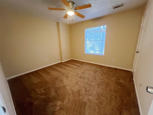 unfurnished room featuring ceiling fan and carpet floors