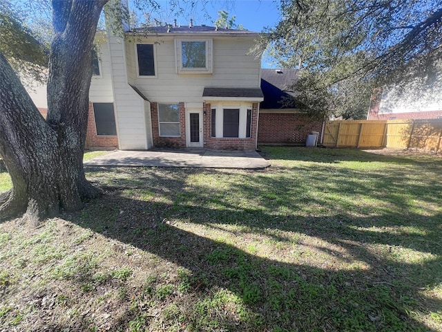 rear view of property with a patio area and a lawn