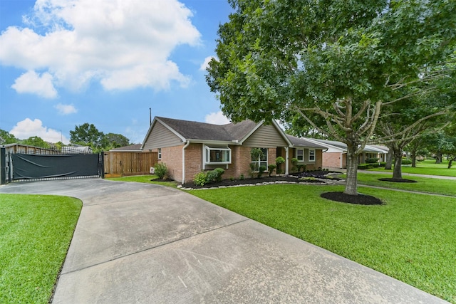 single story home with brick siding, a front yard, fence, and a gate