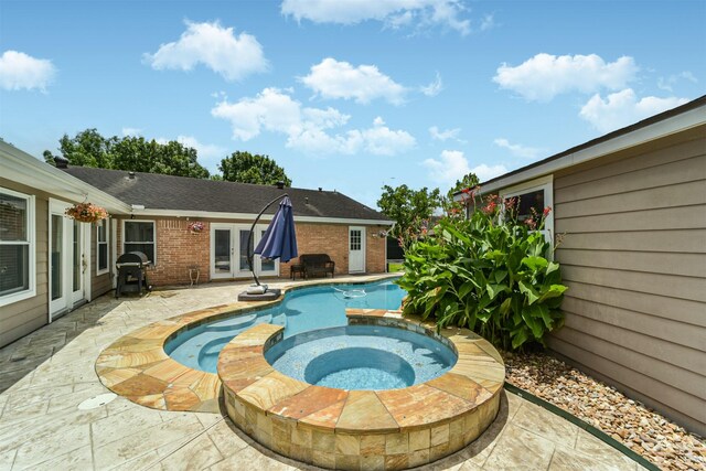 view of pool featuring a patio, french doors, and an in ground hot tub