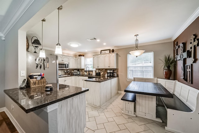 kitchen featuring crown molding, white cabinetry, kitchen peninsula, and hanging light fixtures